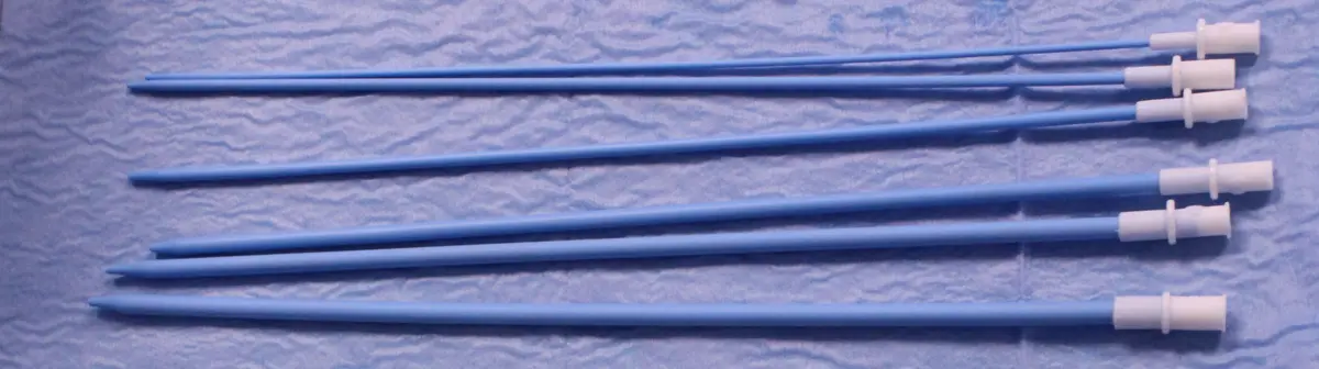 A row of blue Teflon dilators of increasing width.