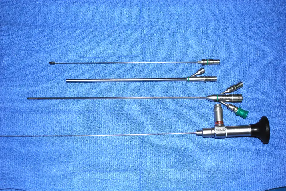 A set of thin telescopes and sheaths for ultra-mini PCNL laid out on a blue drape.